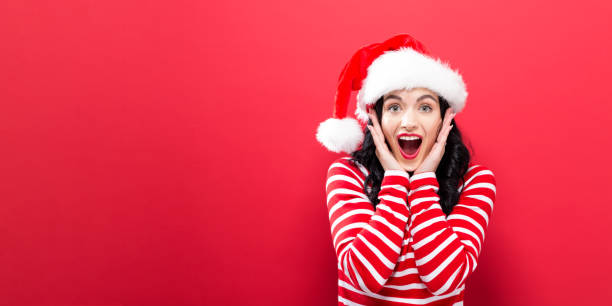 istock Happy young woman with Santa hat 857674852