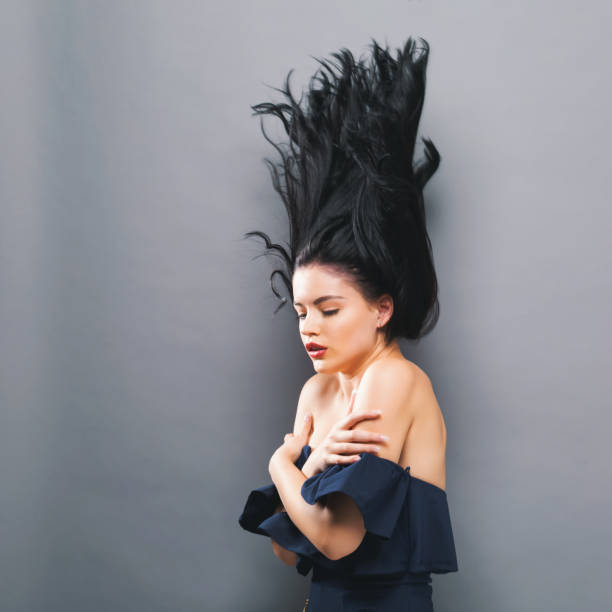 istock Young woman with floating hair 857674882