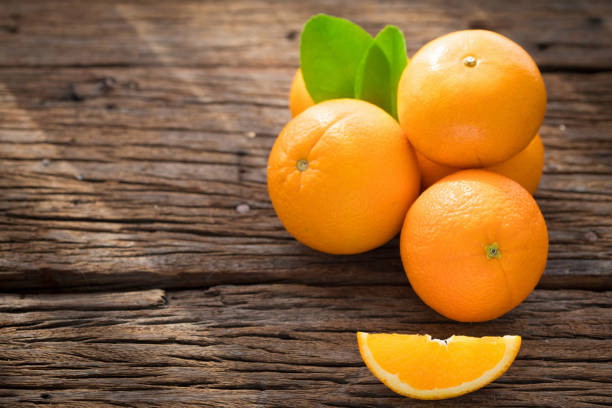 istock Fresh orange fruits on wood table. 857679112