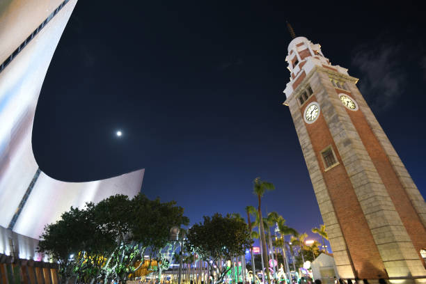 View of full moon during Mid-Autumn Festival at the Cultural Centre Piazza by the Clocktower in Hong Kong View of full moon during Mid-Autumn Festival at the Hong Kong Cultural Centre Piazza by the Clocktower and Tsim Sha Tsui promenade hong kong moon night stock pictures, royalty-free photos & images