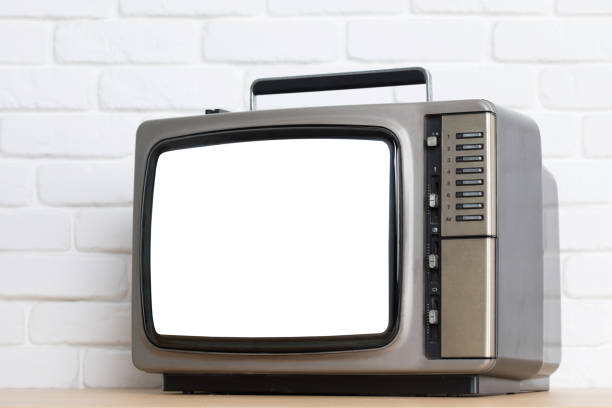 istock Old television with cut out screen on a white brick wall background. 857681296