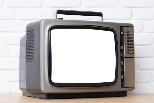 istock Old television with cut out screen on a white brick wall background. 857681312