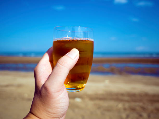 istock glass of tea on hand 857684970