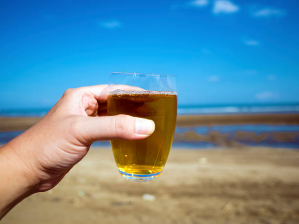 istock glass of tea on hand 857684992
