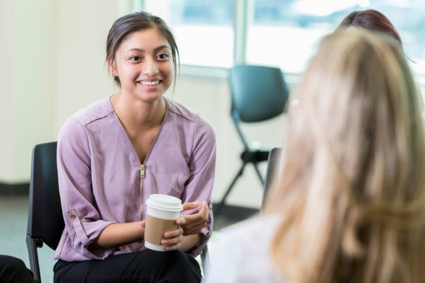 istock Cheerful woman participates in support group meeting 857689132