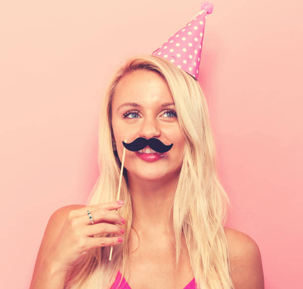 istock Young woman holding paper party sticks 857691978