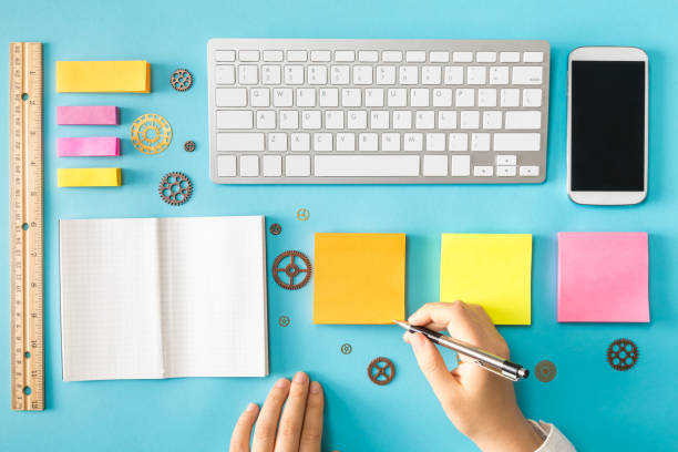 istock Overhead view of workstation with hands 857692928
