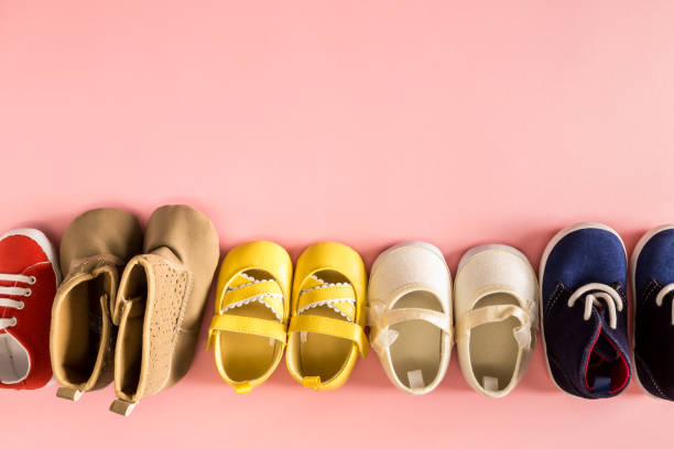istock Baby shoes on a pink background 857692972
