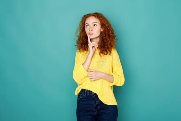 istock Pensive young woman looking upwards 857696434