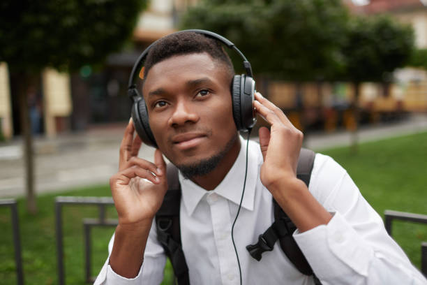 istock African man resting outdoors and listening music 857700518