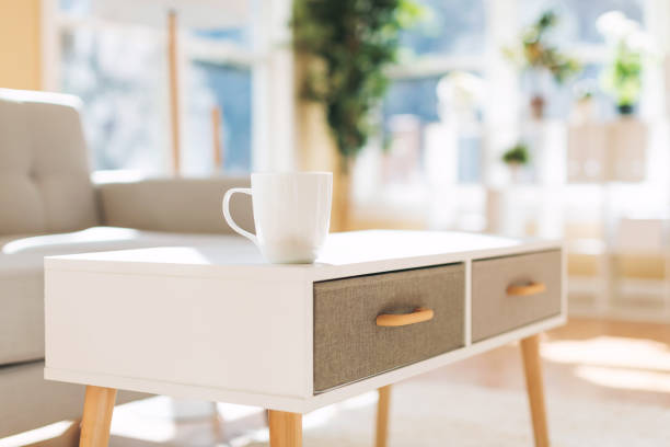 Coffee cup and gray midcentury loveseat