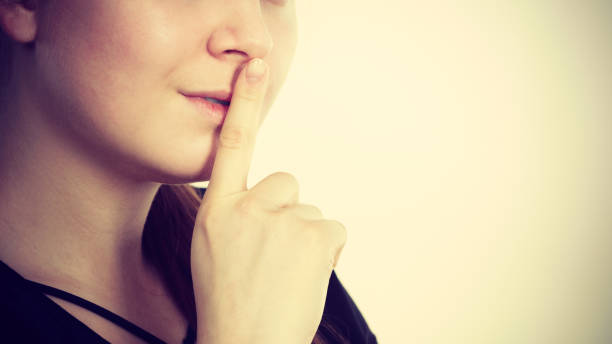 istock Woman showing silence gesture with finger 857712258