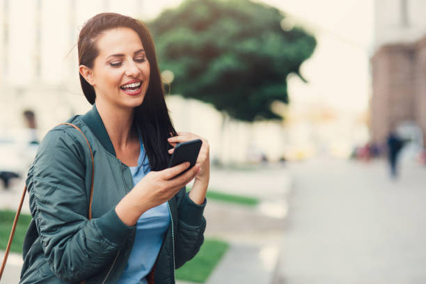 istock Woman texting outdoors 857716184