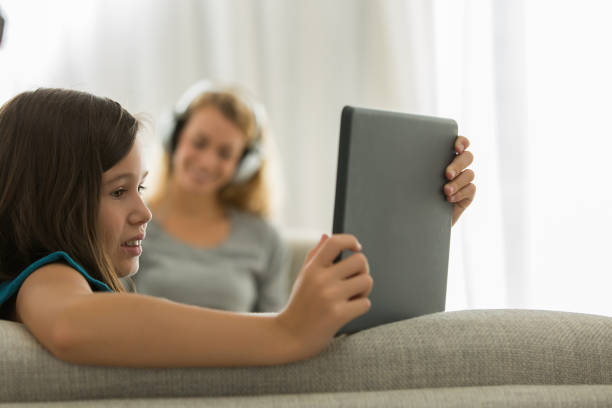 istock Portrait of young girl using tablet at home 857717078