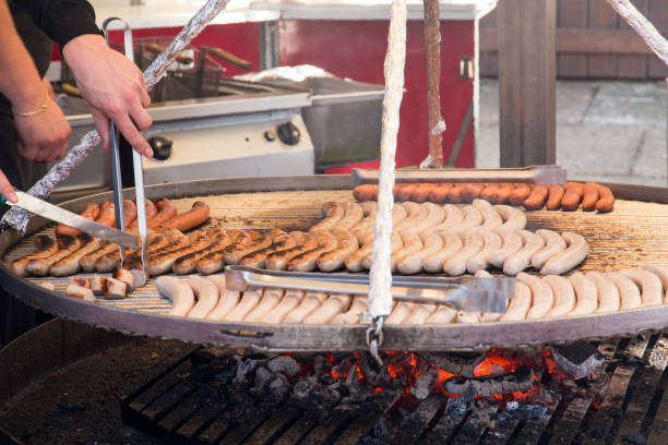 istock men working with a barbecue grill and sausages 857722494