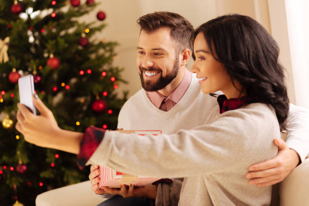 istock Happy international couple taking selfies on Christmas 857723132