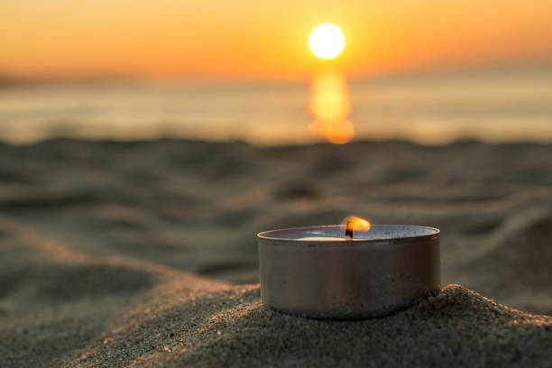 istock Sunrise - beautiful sun, sand and a candle 857723164