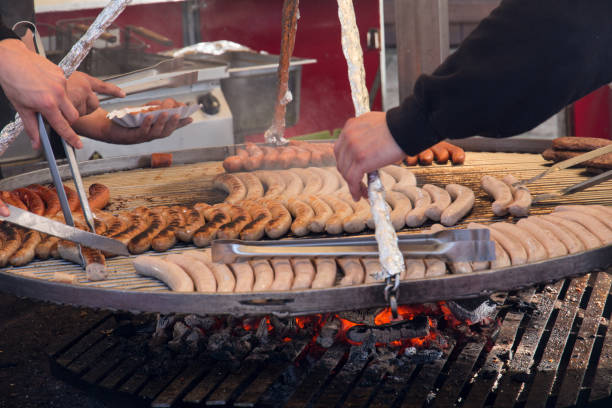 istock men working with a barbecue grill and sausages 857723438