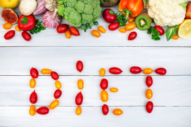 istock Diet written with vegetables tomato on a wooden background. Vegetable top view. 857724454