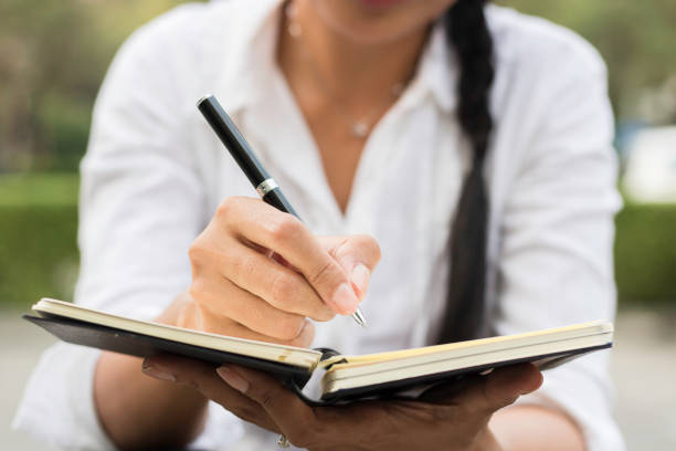 istock A woman writing somethings  in a notebook. 857725158