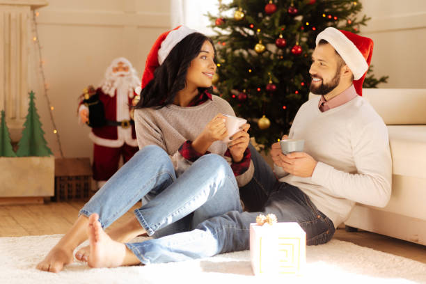 istock Lovely couple talking while drinking coffee on Christmas 857725634