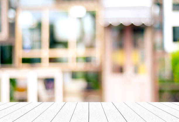 istock Empty white table, perspective wood, over blurred store with bokeh background, product display montage background 857727998