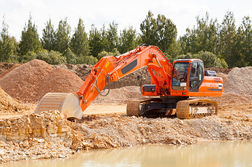 Excavator loader machine during earthmoving works outdoors