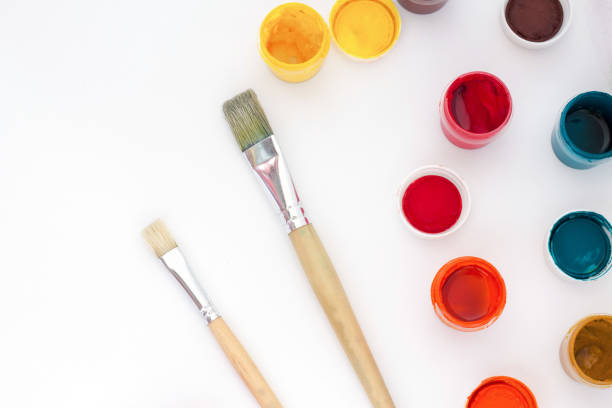 istock Paint jars and brushes on white background top view 857740060