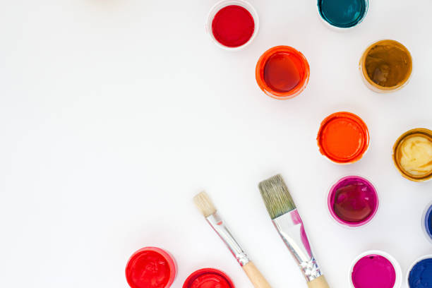istock set of brightly colored paints with brushes on white table backround top view 857740140