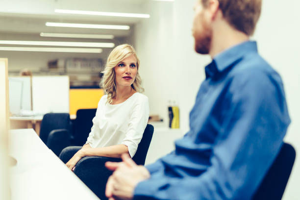 istock Beautiful blonde worker talking with colleague in office 857743472