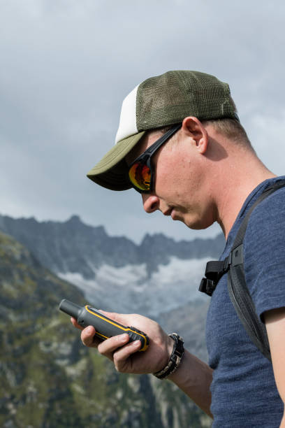 istock Alpinist is oriented with a GPS device in the terrain 857744562