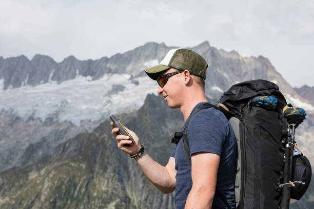 istock Alpinist is oriented with a GPS device in the terrain 857744926