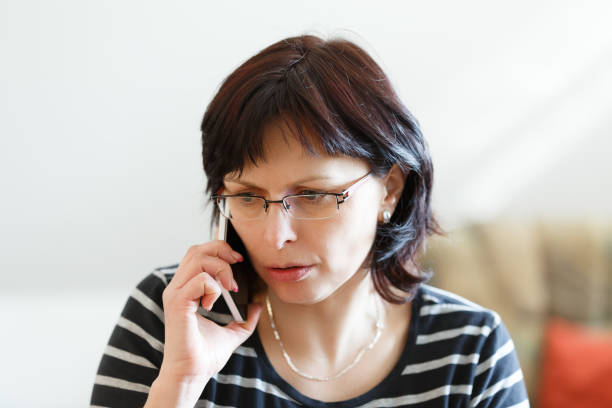istock tired middle-aged woman call by phone 857747474