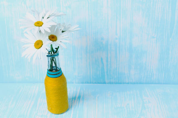 Bouquet of daisies in vase on table