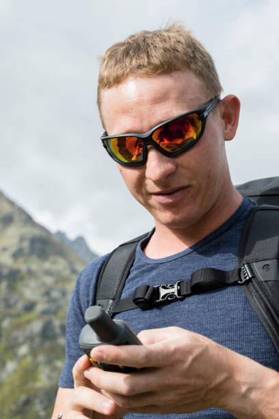 istock Alpinist is oriented with a GPS device in the terrain 857748012