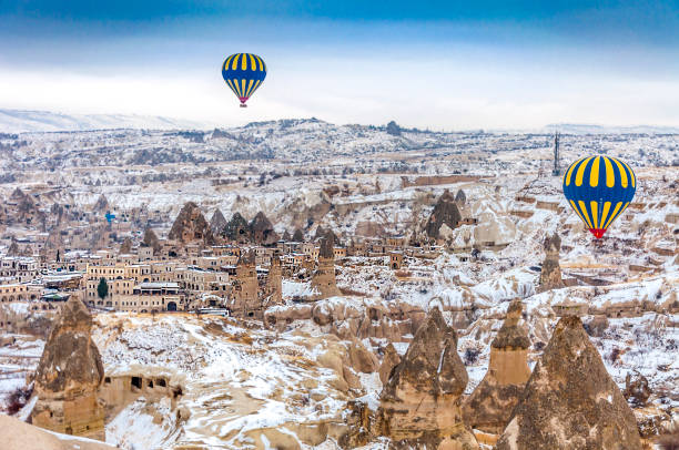 Cappadocia in Turkey Cappadocia, Turkey - December 16, 2013 : Early morning in Cappadocia, Turkey, hot air balloons offer guests from all over the world spectacular views of the Cappadocian landscape. cappadocia winter photos stock pictures, royalty-free photos & images