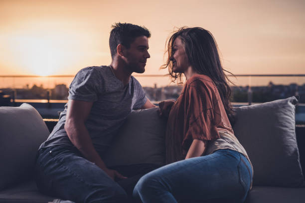 istock Affectionate couple flirting on a penthouse terrace at sunset. 857758856