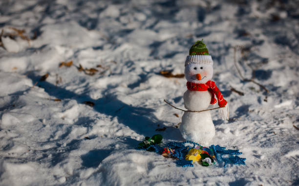 istock Snowman on snow over blurred christmas tree and gift box on glitter light bokeh background with copy space 857759476