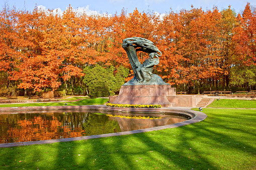 Friderick Chopin monument in autumn Lazienki Park (Royal Baths Park) in Warsaw, Poland