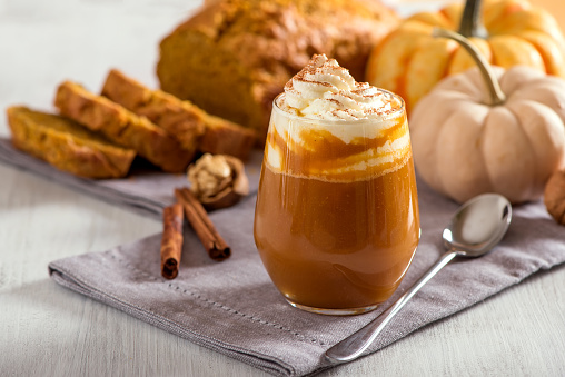 Pumpkin spice latte, hot coffee drink with pumpkins and pumpkin cake bread, healthy autumn dessert food