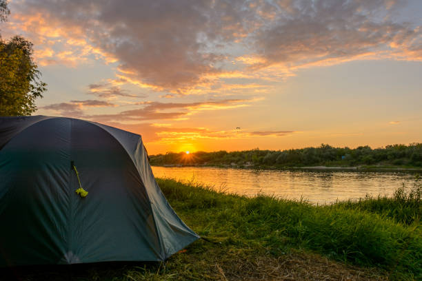 istock Camping tent on the river bank at sunset background 857767760