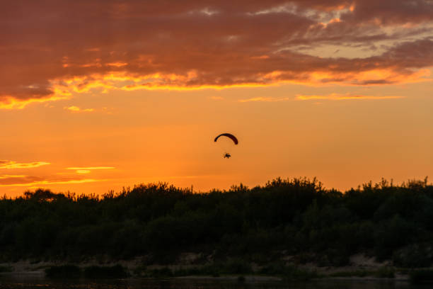 istock Paragliding in the sky over the river 857767990