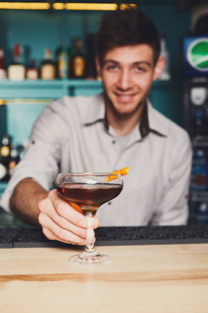 istock Bartender offers alcoholic cocktail in bar 857768106
