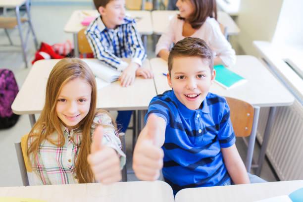 istock group of school kids showing thumbs up 857768690