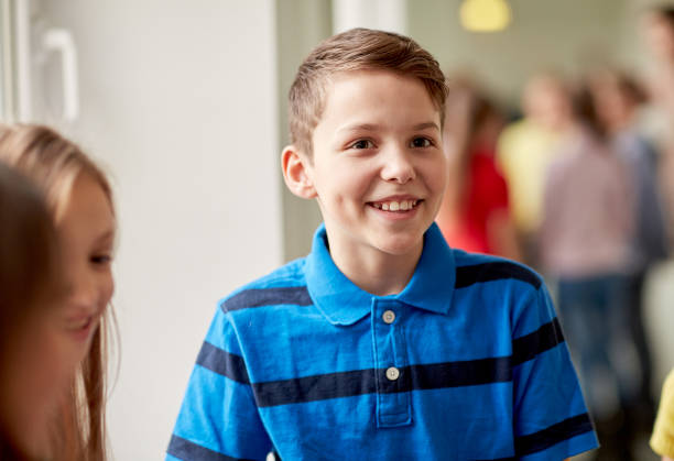 istock group of smiling school kids in corridor 857768728