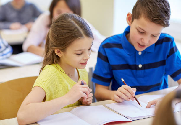 istock group of school kids writing test in classroom 857768840