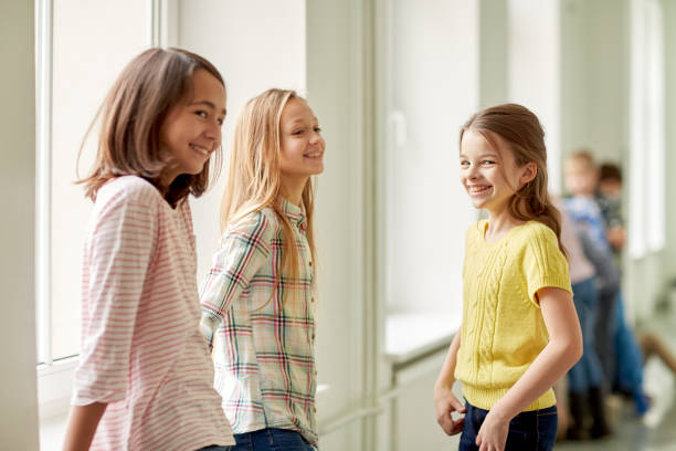 istock group of smiling school kids in corridor 857769026