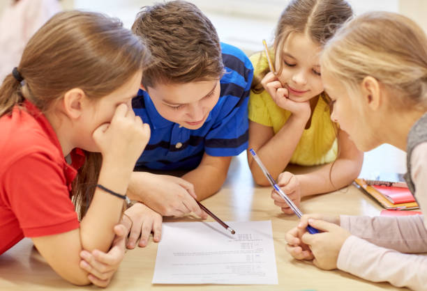 istock group of students talking and writing at school 857773828