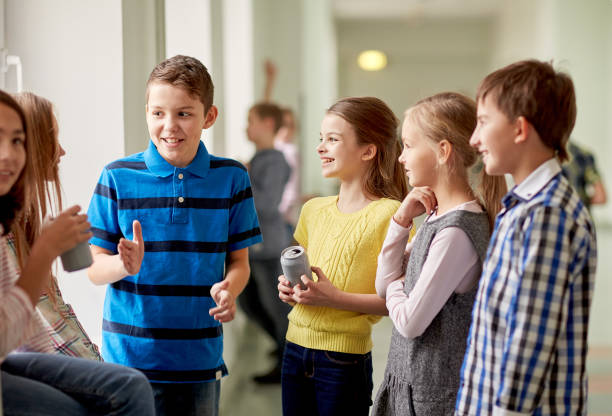 istock group of school kids with soda cans in corridor 857774532