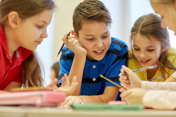 istock group of students talking and writing at school 857774586